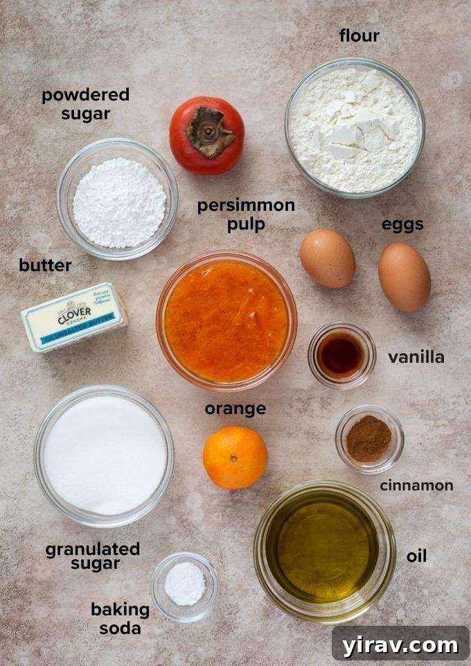 A selection of fresh persimmons, baking spices, and other essential ingredients for making persimmon cake.