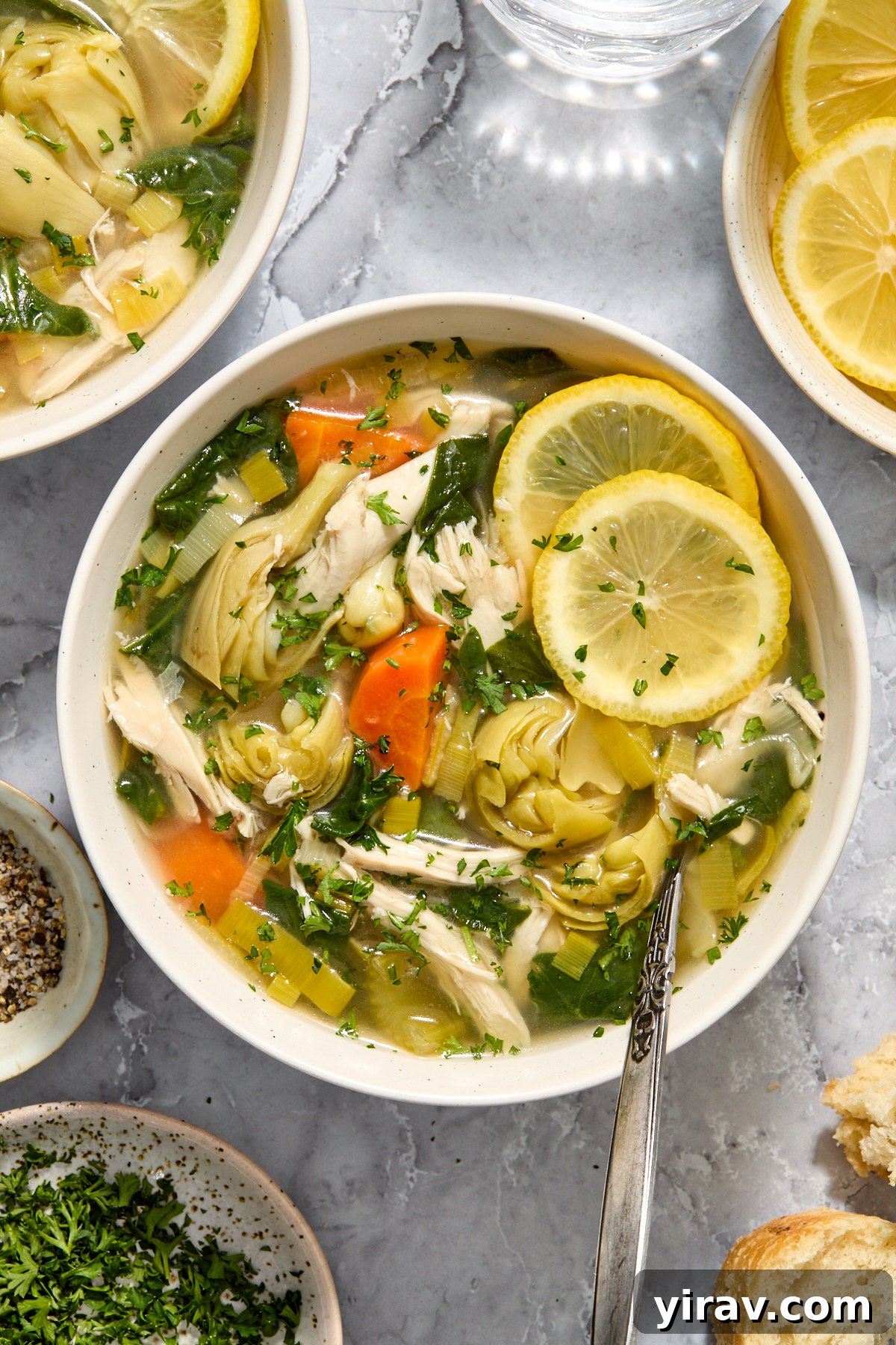 Slow cooker lemon chicken artichoke soup in a bowl.
