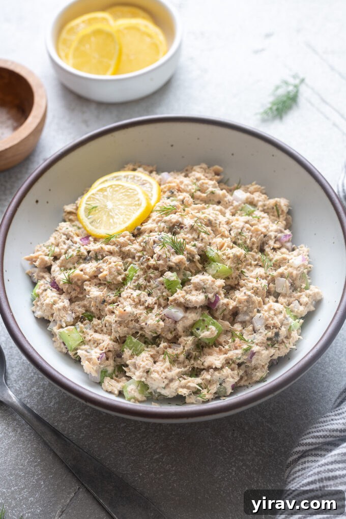 Canned salmon salad in a serving bowl with lemon.