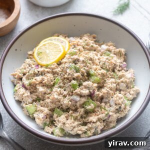 Canned salmon salad in a serving bowl with lemon.