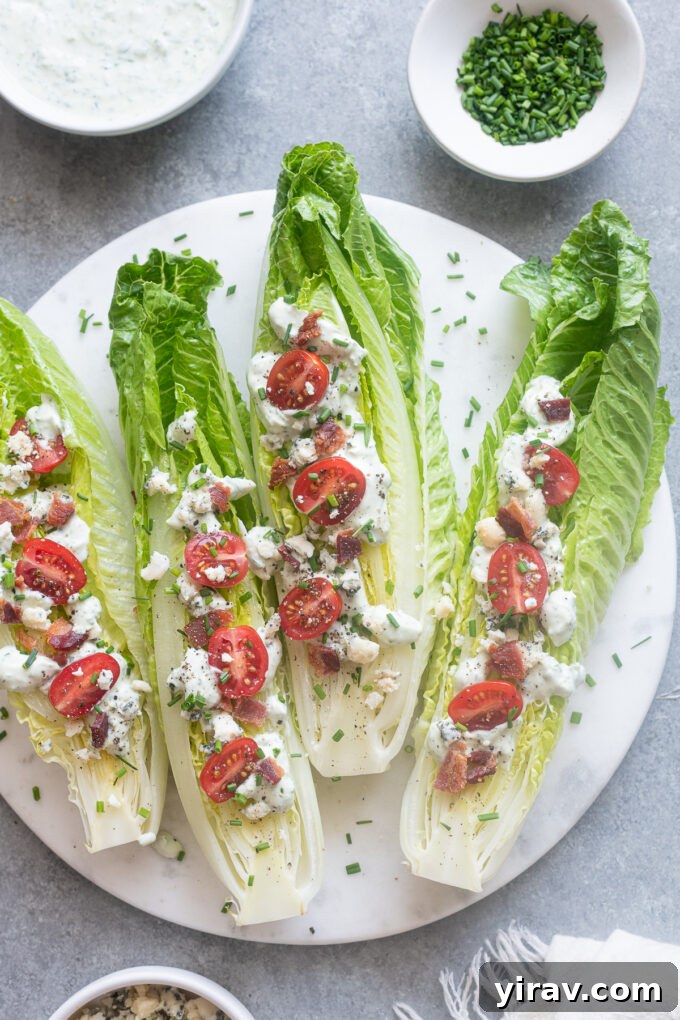 Multiple Romaine Wedge Salads arranged artfully on a large platter, each topped with a generous amount of Green Goddess dressing and fresh ingredients.