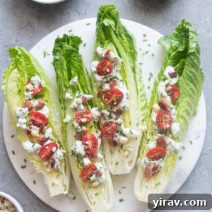 Romaine wedge salad with bacon and blue cheese on a platter.