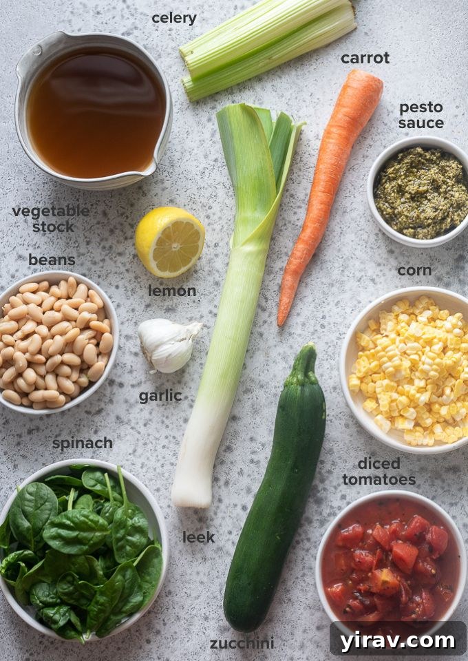 Various fresh ingredients for Soupe au Pistou recipe laid out on a surface.