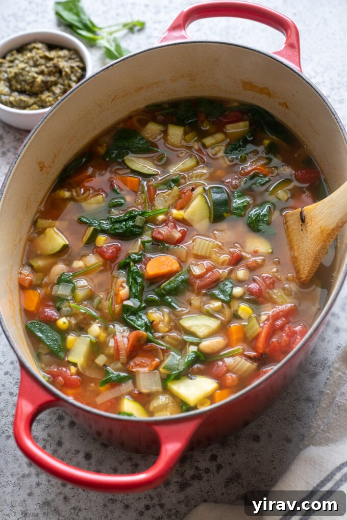 Large pot of Summer Vegetable Soup simmering in a Dutch oven, ready to be served.
