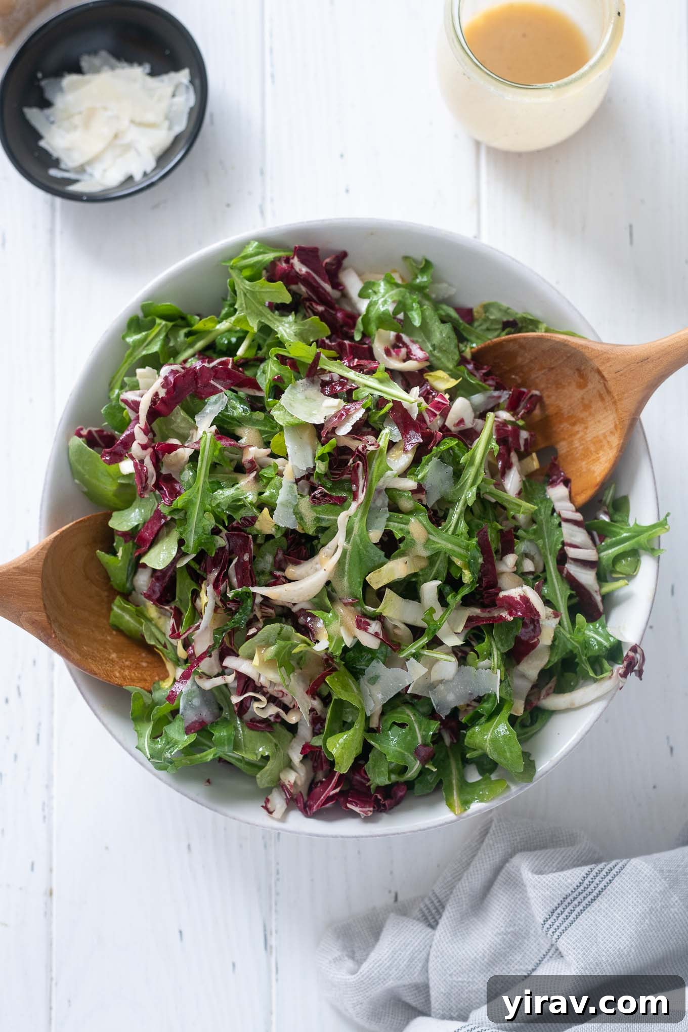 Tricolore salad in a bowl with wooden servers