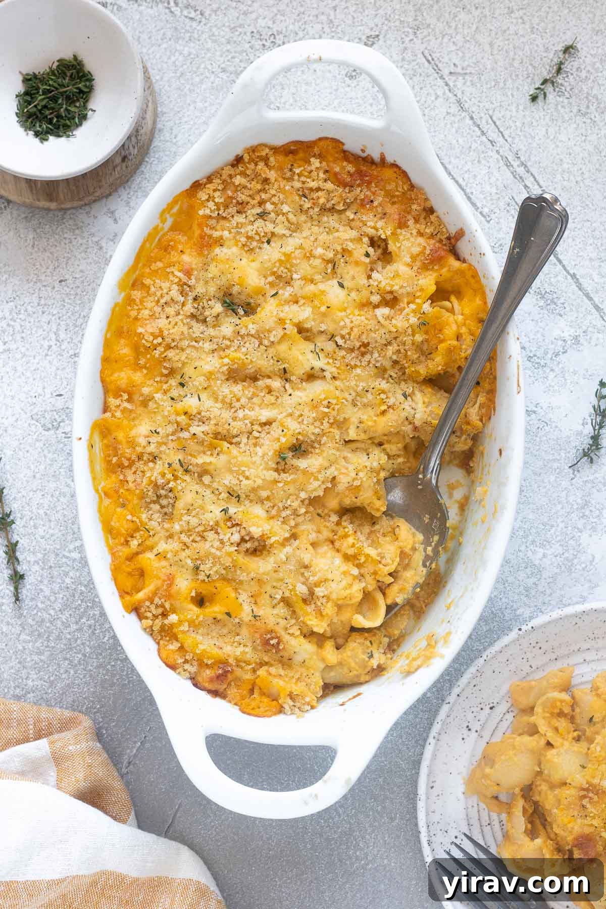 Butternut squash mac and cheese with breadcrumbs on top.
