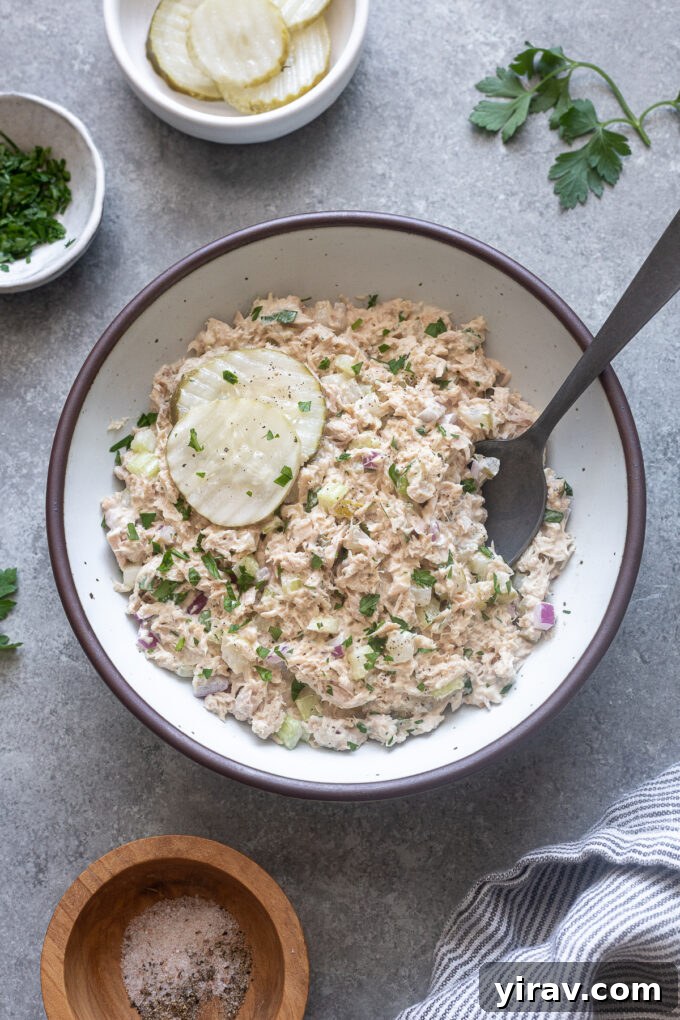 Zesty Dill Pickle Tuna 2 A bowl of creamy, crunchy Dill Pickle Tuna Salad garnished with fresh parsley.
