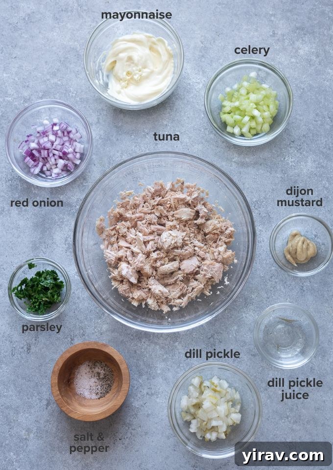 Zesty Dill Pickle Tuna 4 All the fresh ingredients needed for a delicious Dill Pickle Tuna Salad, laid out on a white surface.