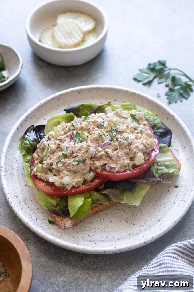 Zesty Dill Pickle Tuna 9 Easy dill pickle tuna salad served open-faced on toasted bread, garnished with parsley.