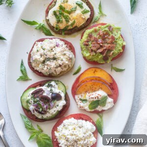 Heirloom tomato flight on a white platter with basil.