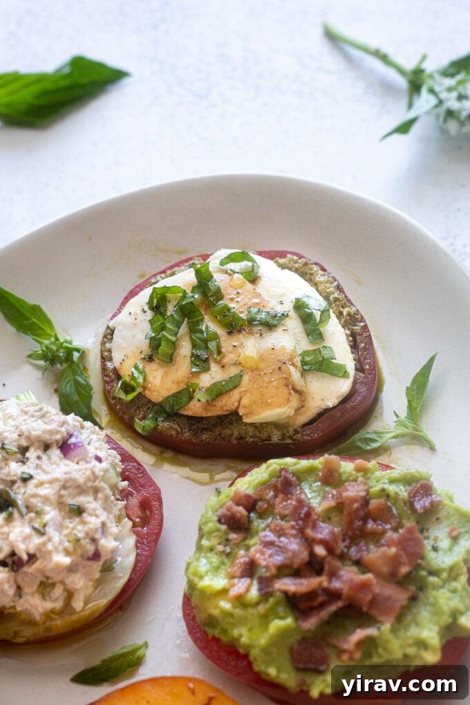 Heirloom tomato slice topped with pesto, mozzarella, and basil for a Caprese flavor.
