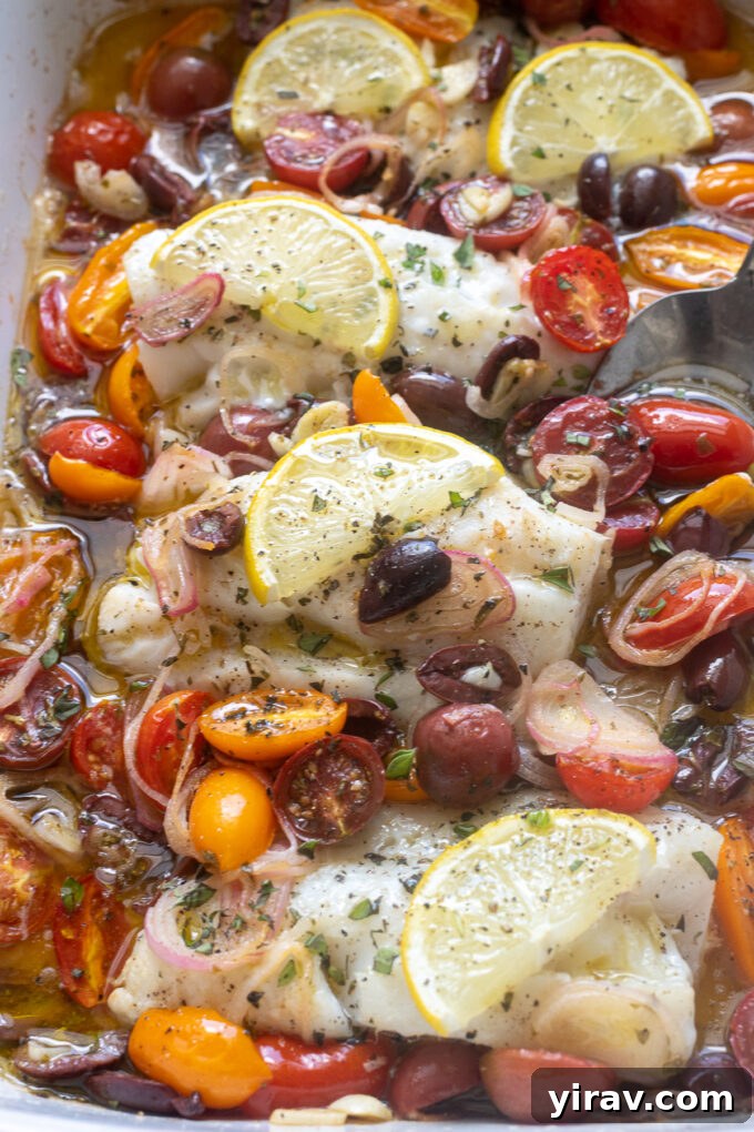 Mediterranean baked cod fish with olive and tomatoes.