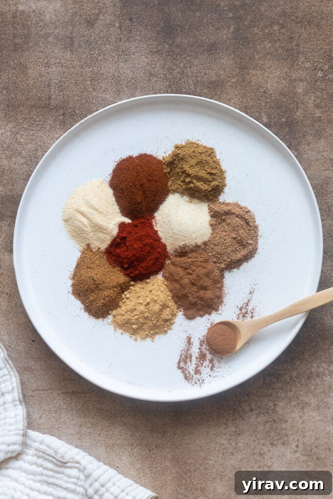 A collection of 10 essential spices neatly arranged on a round white plate, ready for culinary use.
