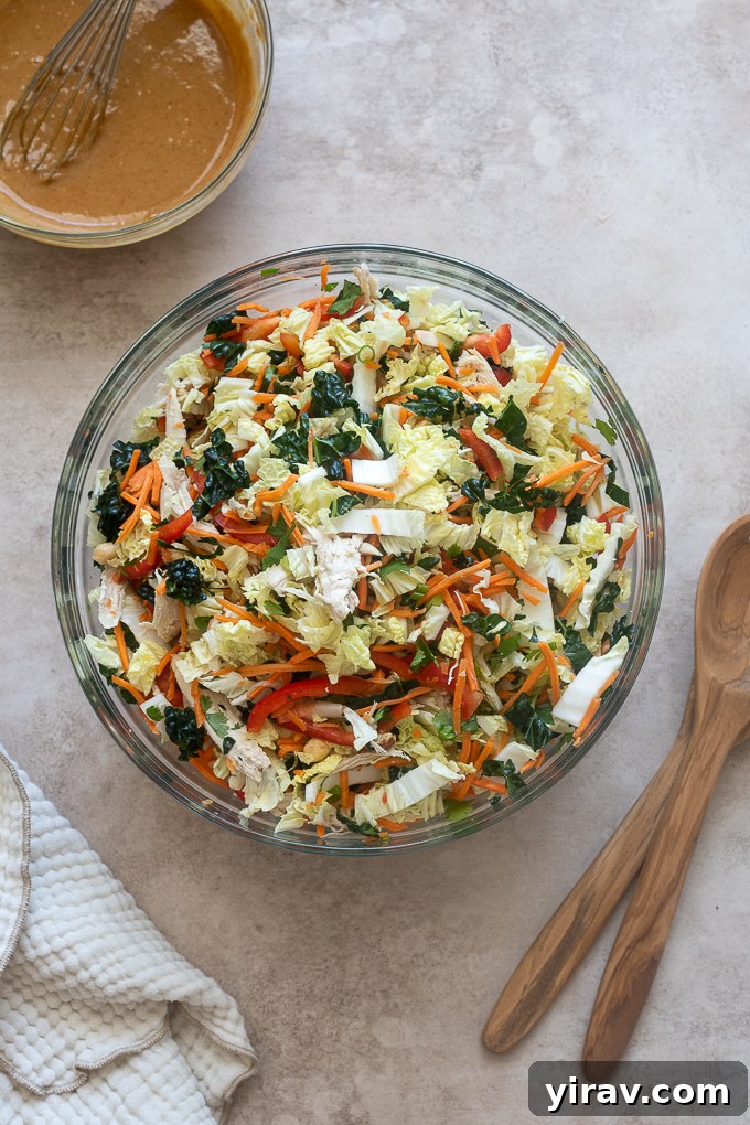 Thai peanut salad ingredients combined in mixing bowl.