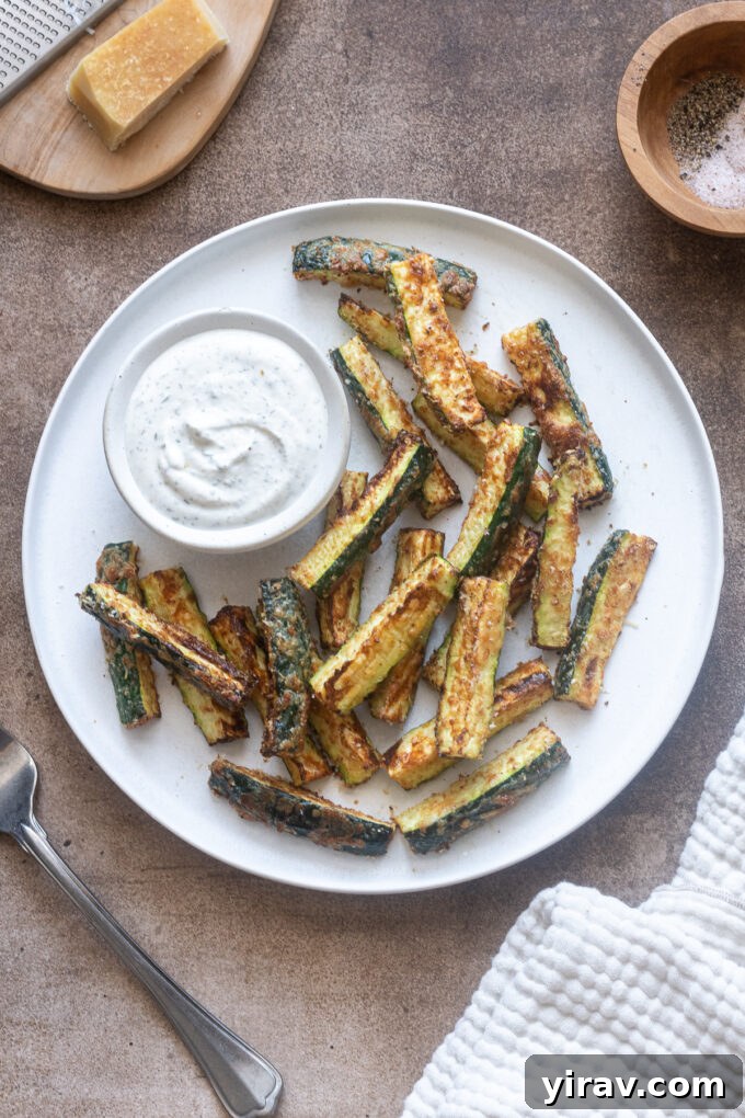 Crispy Air Fried Zucchini Sticks 3 Air fryer zucchini fries on a plate with Greek yogurt ranch dip.
