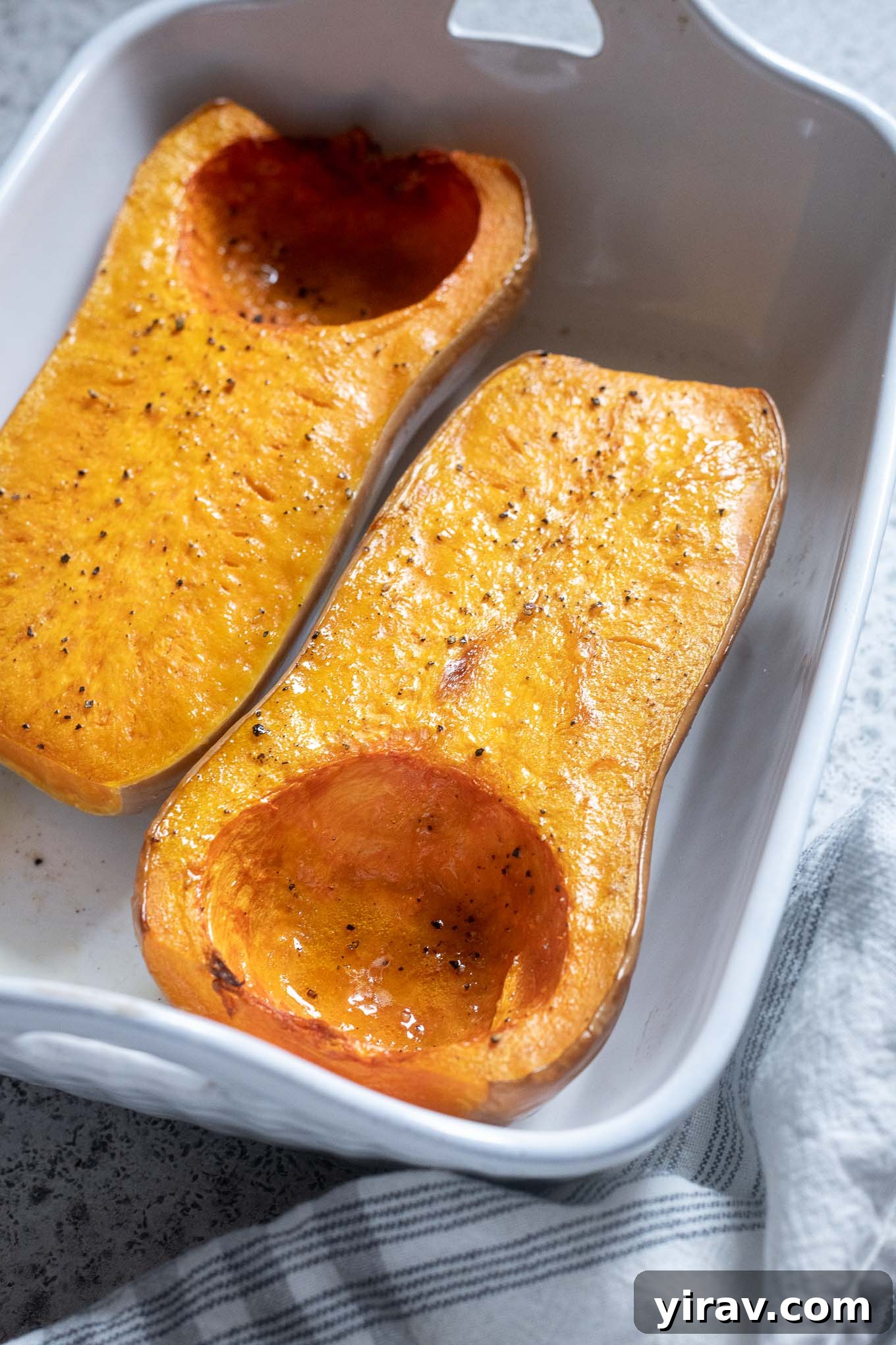 Roasted whole butternut squash in a baking dish