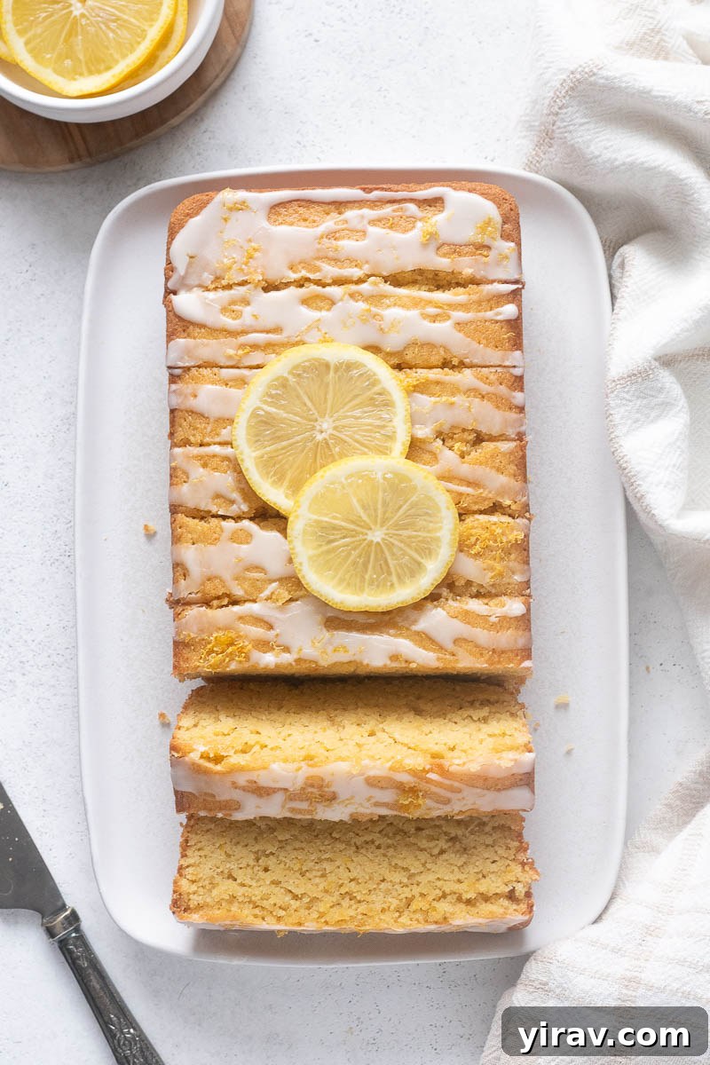 Almond flour lemon loaf cake sliced on a serving platter.
