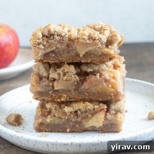 Golden Crumb Apple Pie Bars 11 Stack of apple pie bars on a plate.