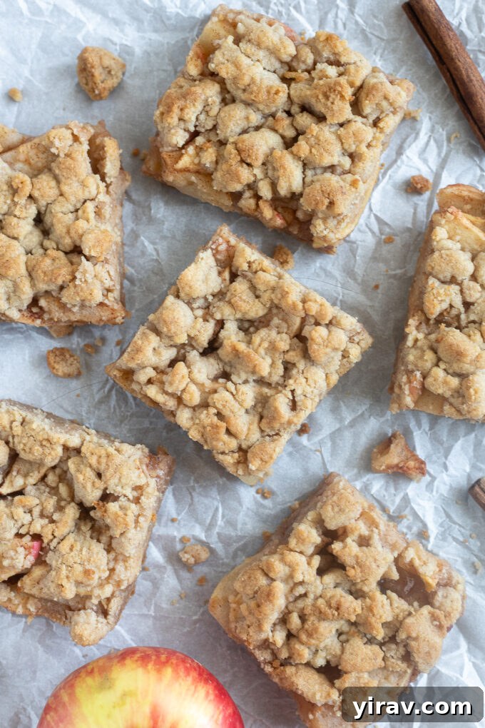 Golden Crumb Apple Pie Bars 3 Easy apple pie bars baking on parchment paper, fresh out of the oven.