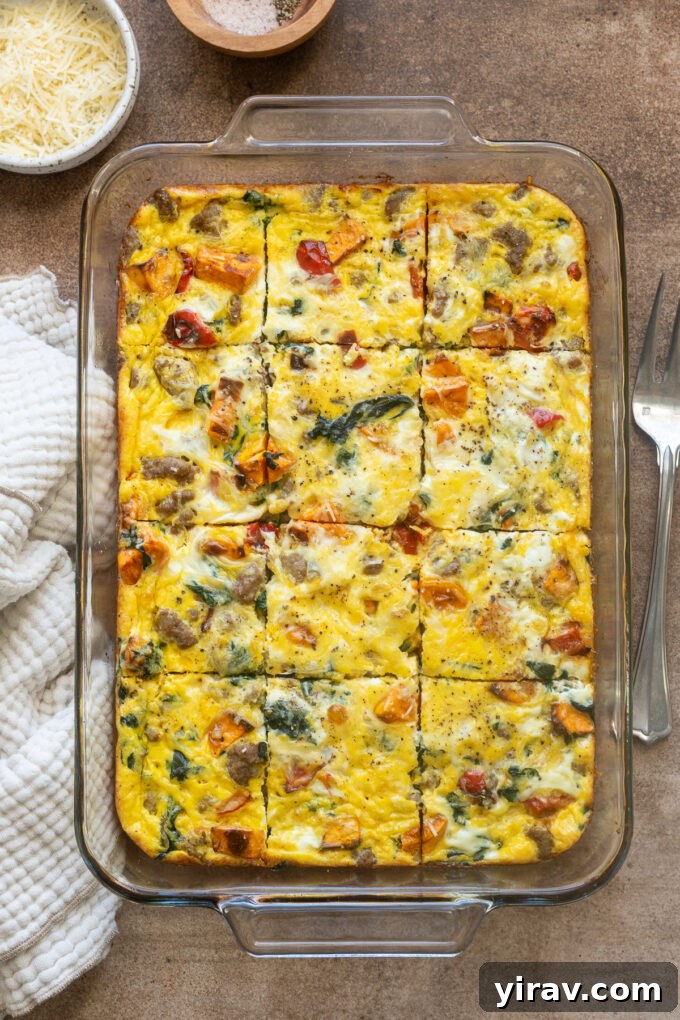Sausage and egg breakfast casserole sliced in baking dish.