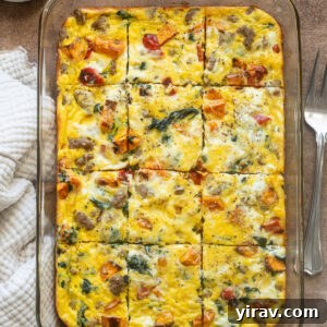 Sausage and egg breakfast casserole sliced in baking dish.