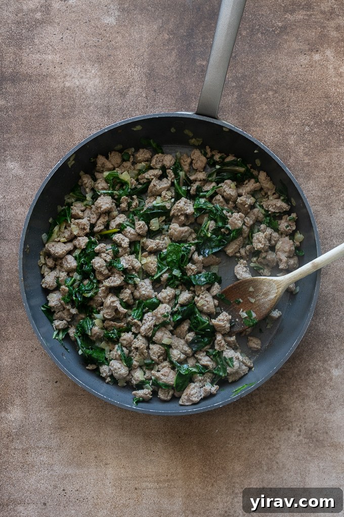 Breakfast sausage filling cooked in skillet for breakfast casserole with sausage.