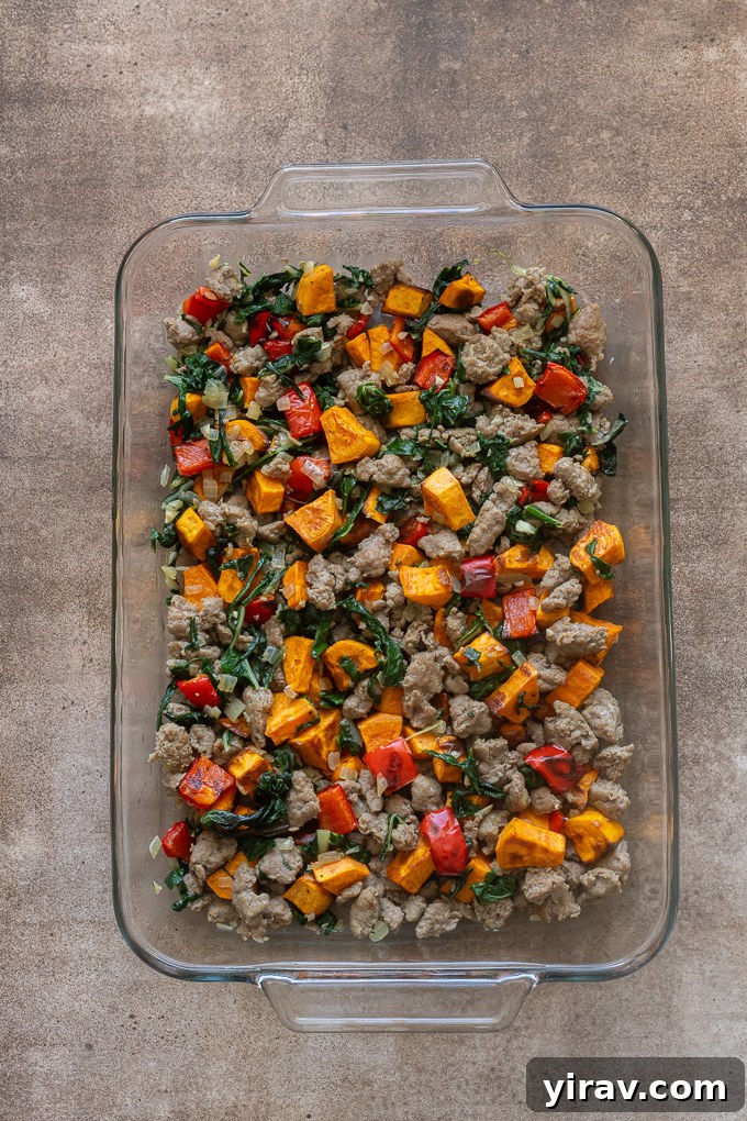 Filling for sausage and egg breakfast casserole in baking dish.