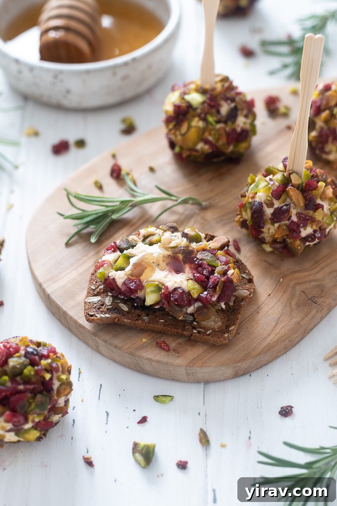 Mini goat cheese ball spread on a cracker, showing creamy texture