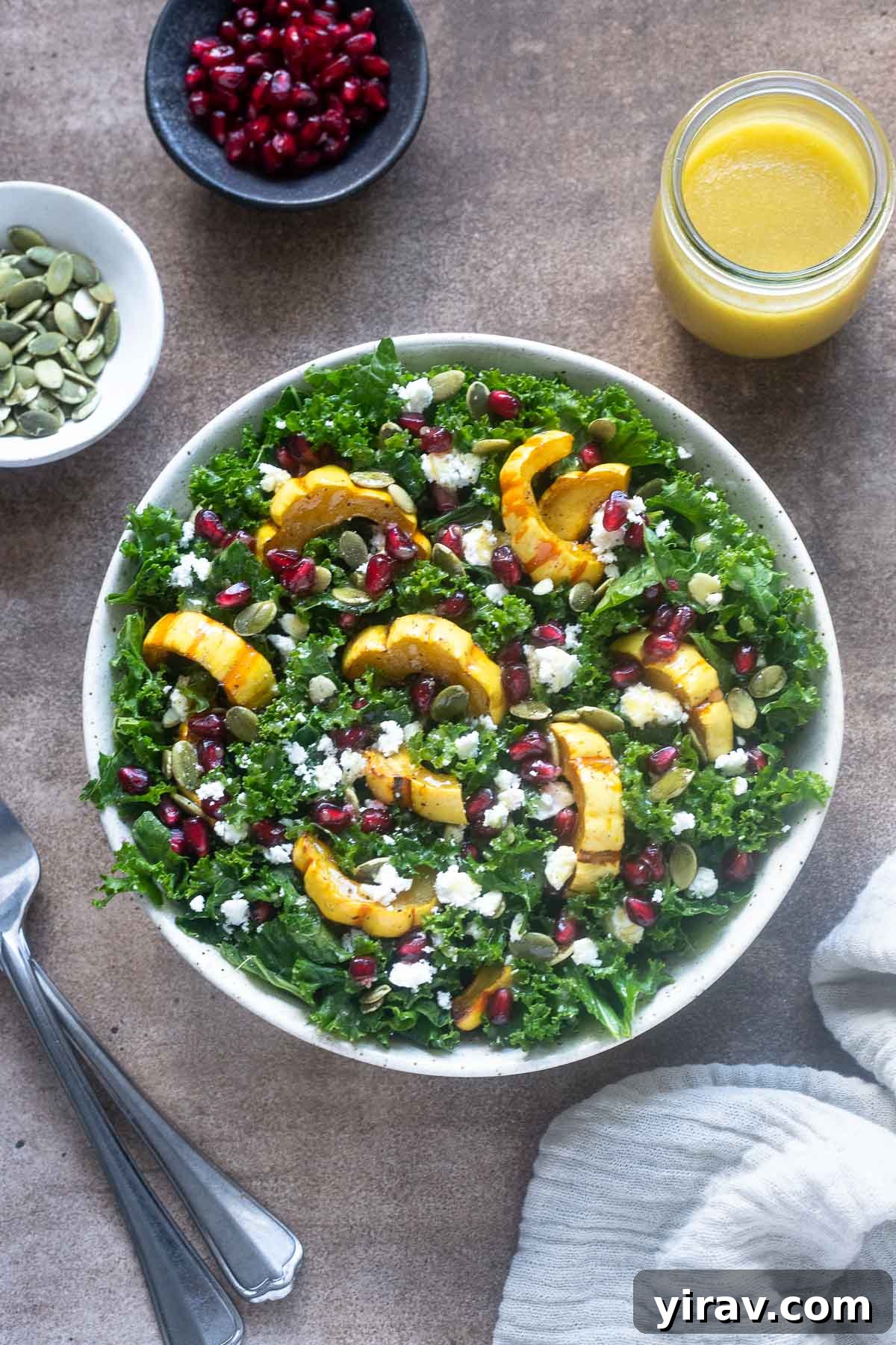 Delicata squash salad in a bowl with dressing on the side.