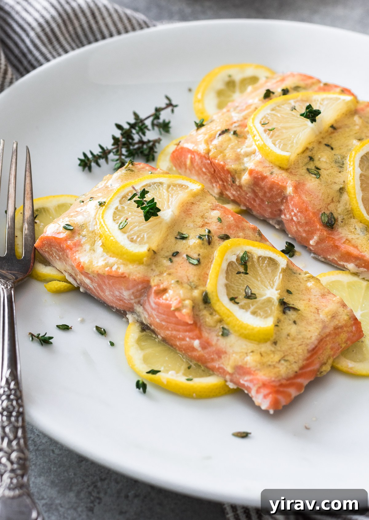 A perfectly baked Dijon salmon fillet on a plate, ready to serve.