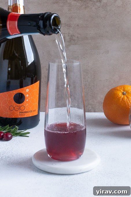 Add champagne or prosecco to the cranberry juice mixture.