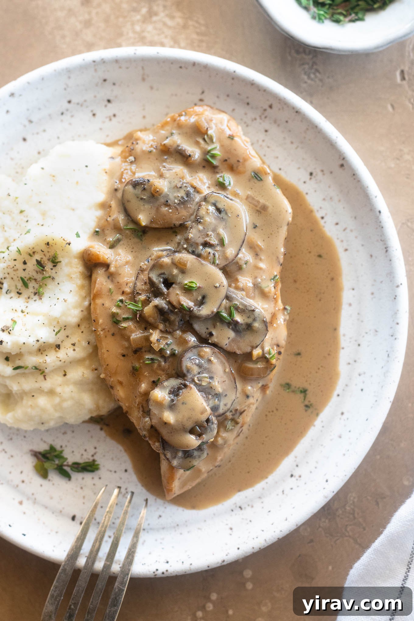 Creamy chicken marsala on a plate with mashed potatoes