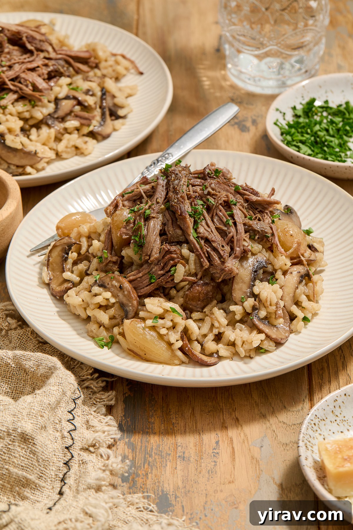 Plate of short rib risotto with parsley garnish.