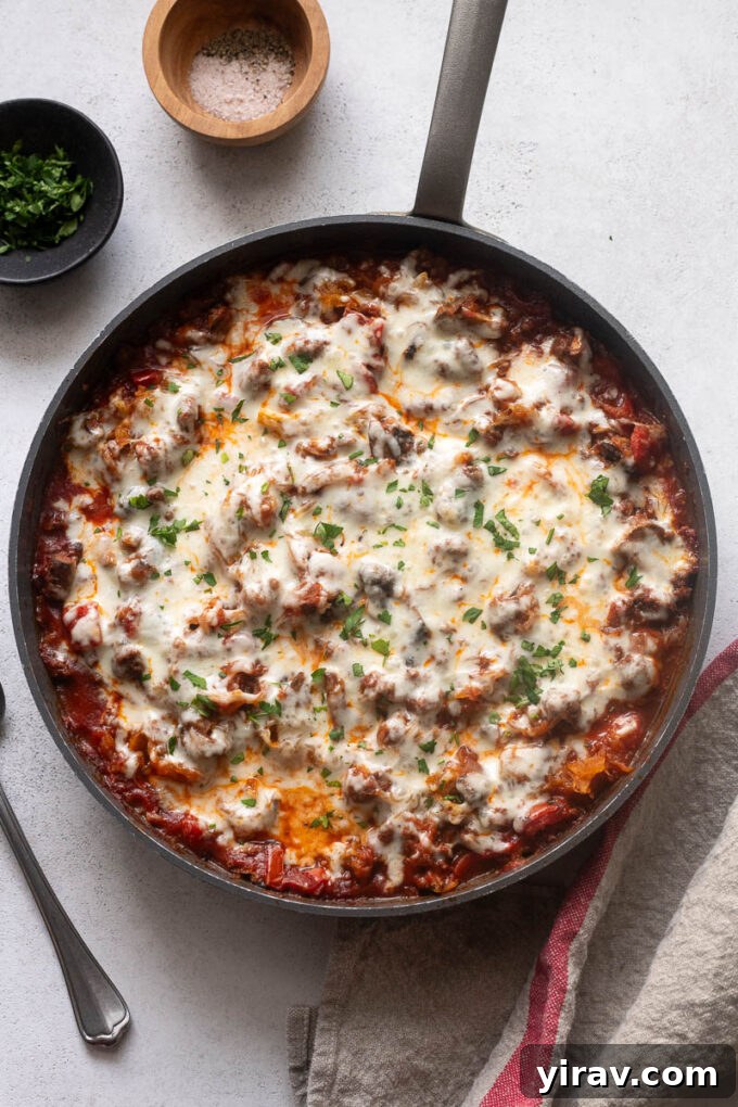 Spaghetti squash with ground beef casserole in a skillet, showcasing its golden crust.