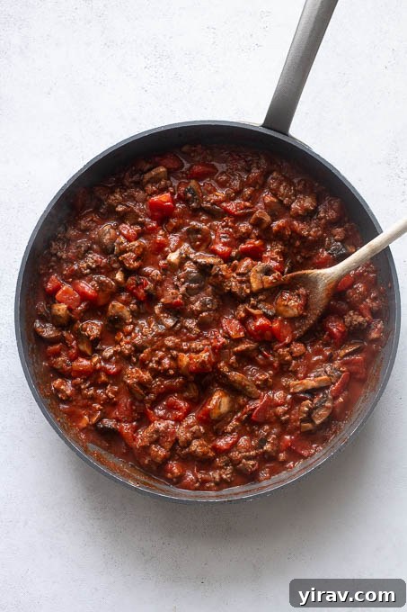 Tomato sauce beef mixture for spaghetti squash casserole, illustrating the sauce preparation.