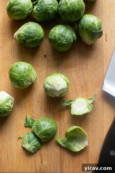 Trim the bottoms of the brussels sprouts and remove the tough outer leaves.