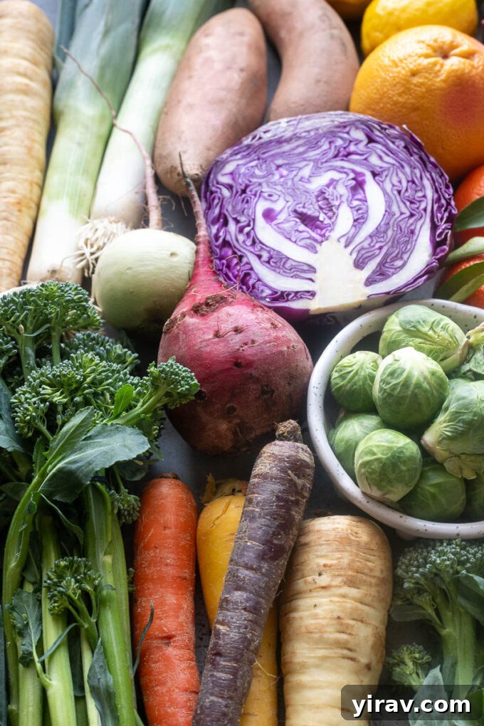 An array of classic winter fruits and vegetables, such as colorful beets, various citrus fruits, and fresh carrots, ready for cooking.