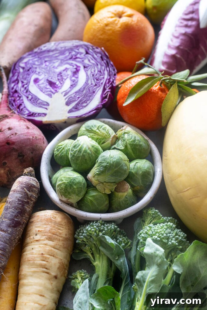An inviting assortment of fresh cruciferous vegetables commonly found in season during February, including Brussels sprouts, cauliflower, and cabbage.