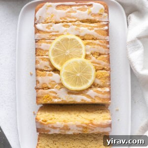 Almond flour lemon loaf cake sliced on a serving platter, highlighting its perfect texture.