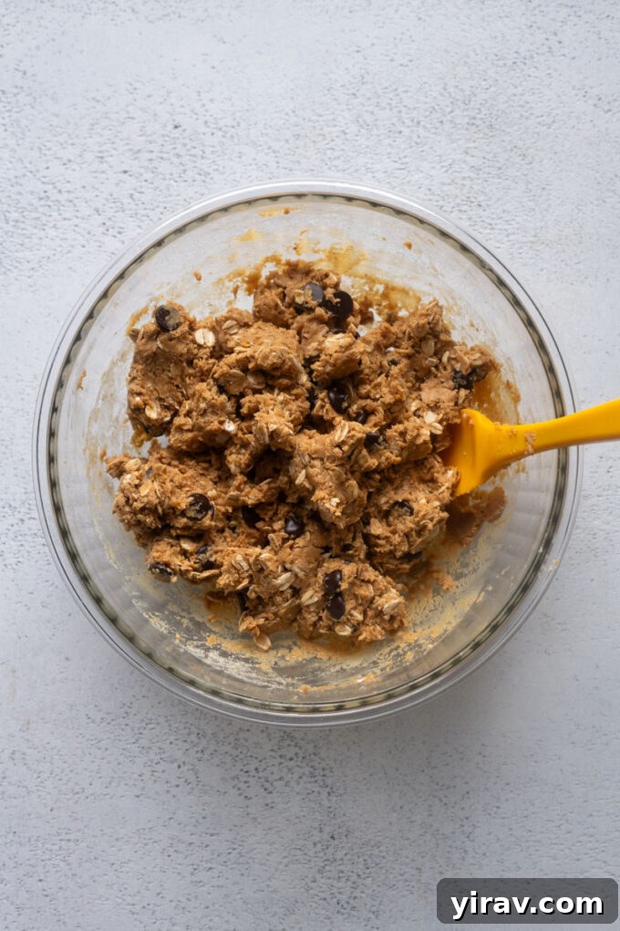Peanut butter protein ball dough with dry ingredients combined in a bowl.