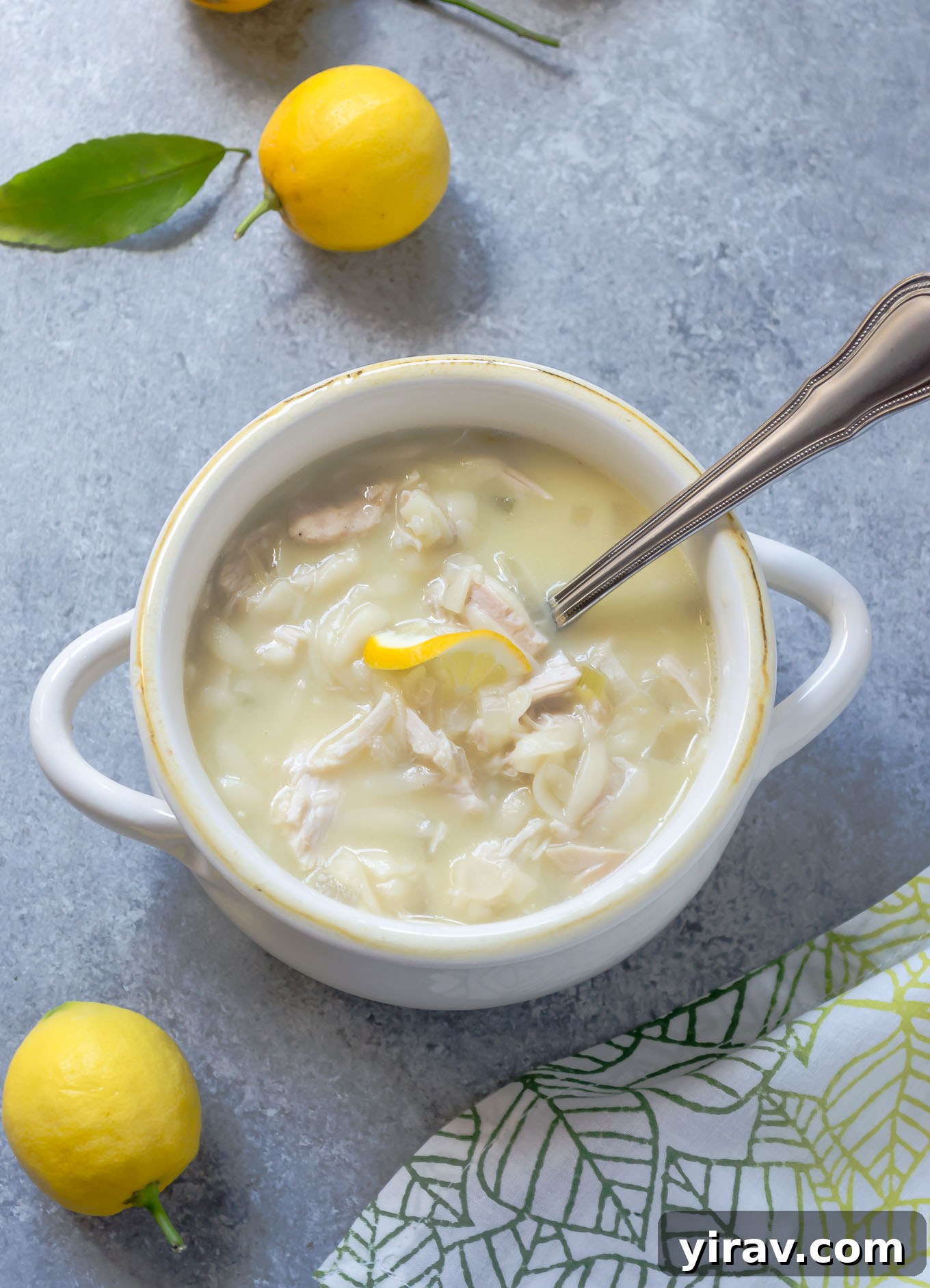 Slow cooker Greek lemon chicken soup in a white bowl