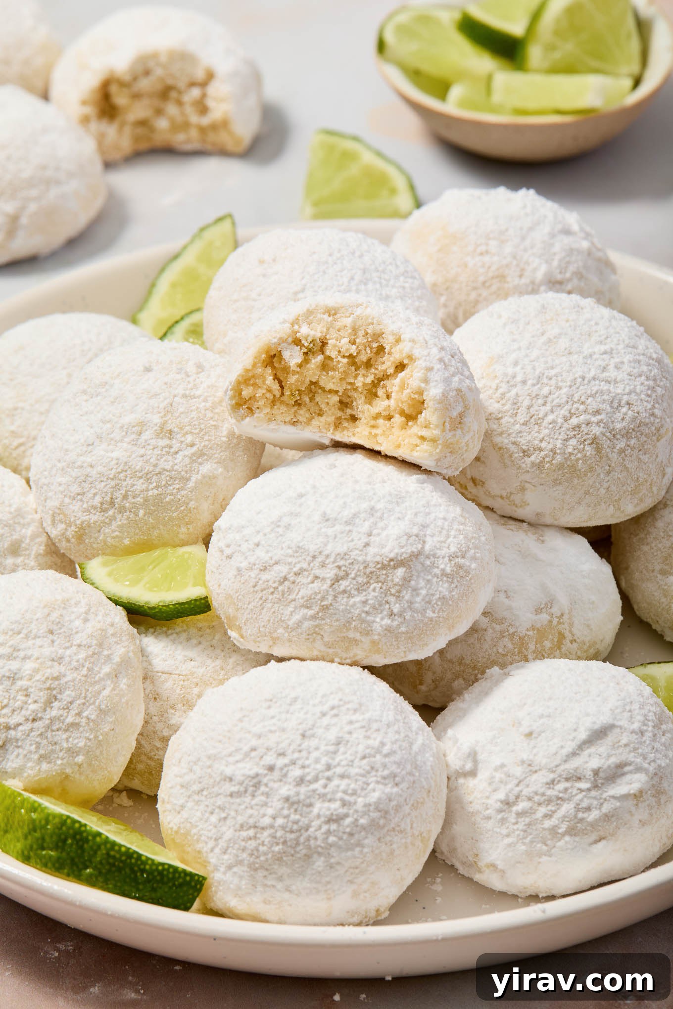 Key lime cooler cookies on a plate with bite out of top cookie.