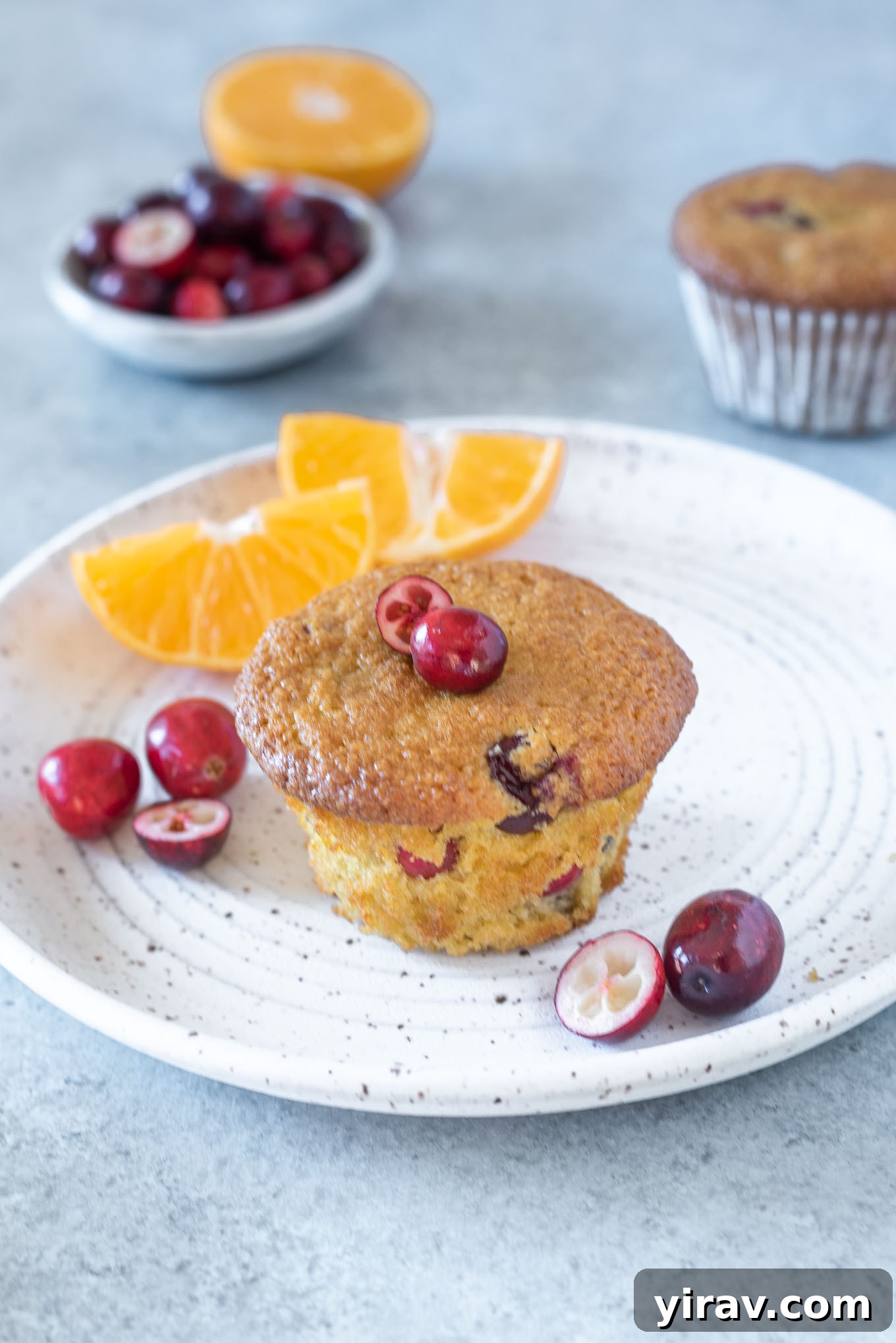 Healthy cranberry orange muffin on a white plate