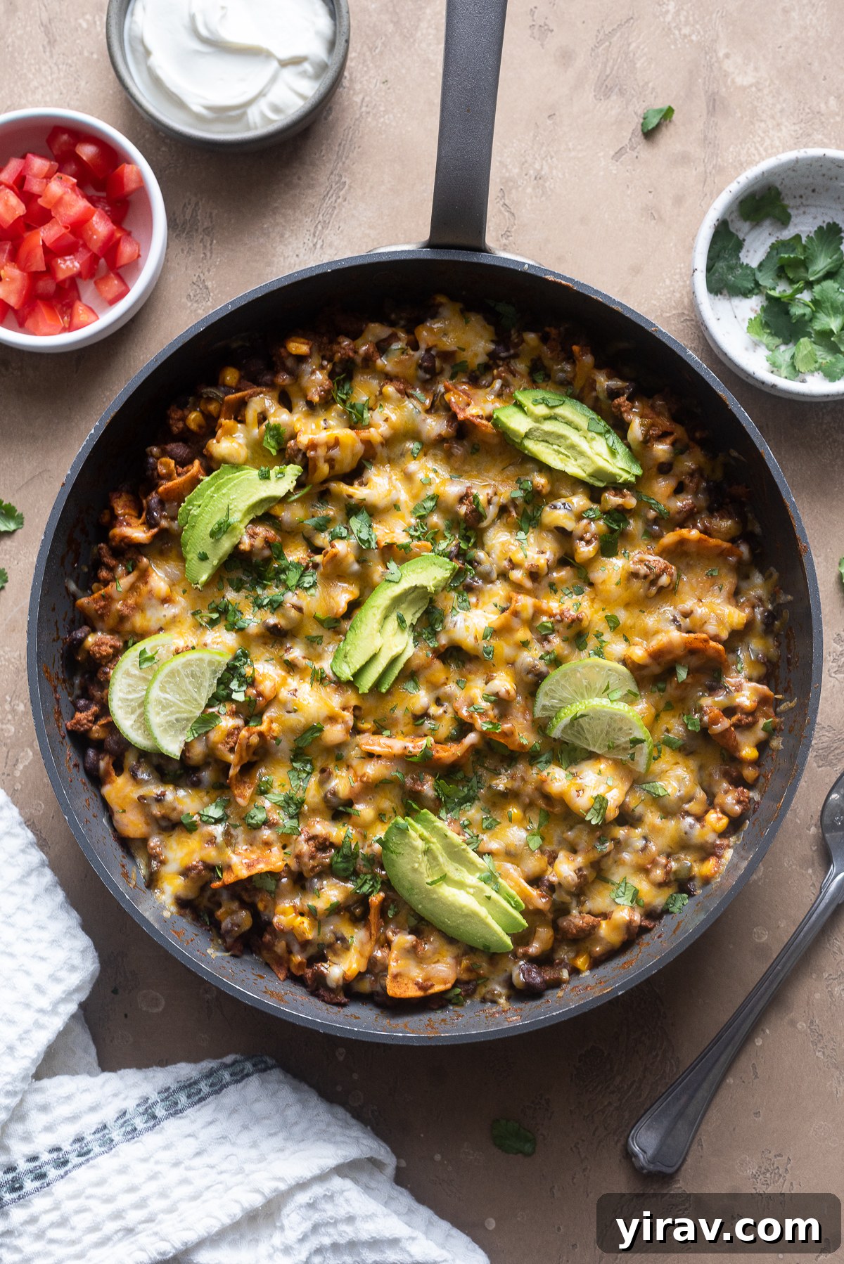 Ground beef enchilada casserole in skillet.