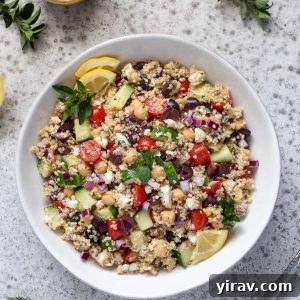 Greek quinoa salad in a white bowl