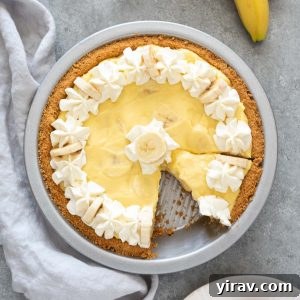 Banana cream pie with serving on a plate nearby