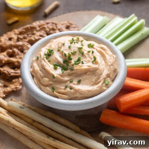Homemade Cheddar Pub Cheese in a bowl topped with chives.