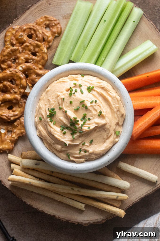 Artisan Cheddar Pub Spread 8 Cheddar pub cheese in a bowl topped with chopped chives.