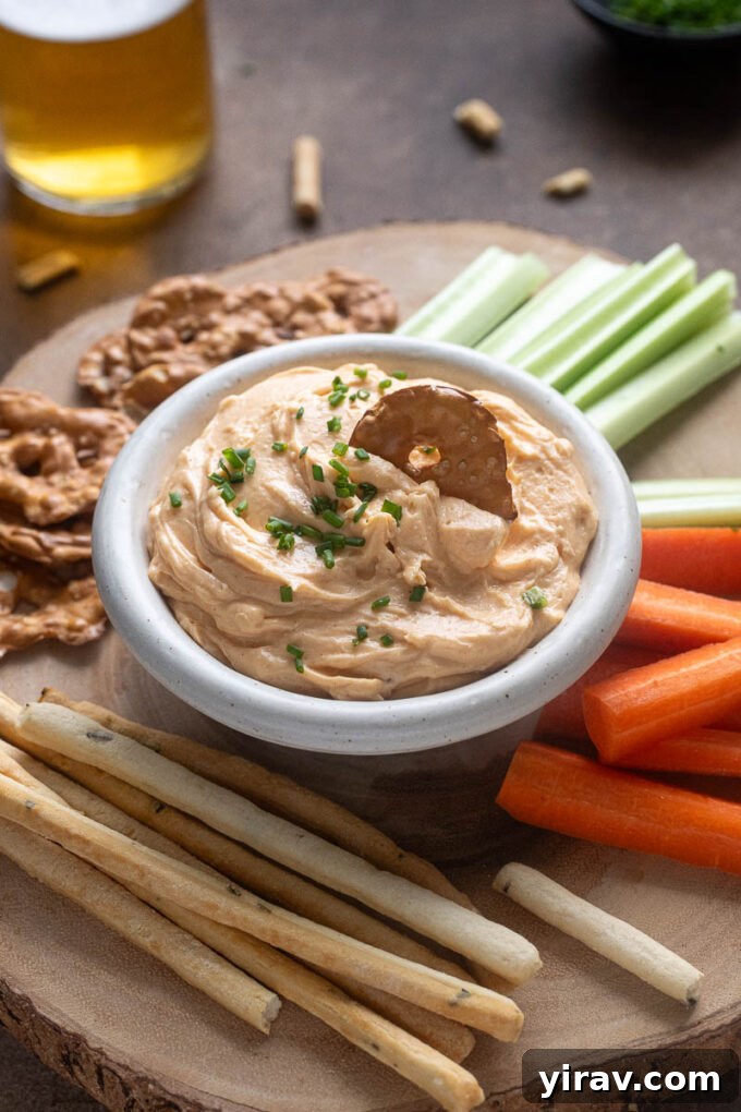 Artisan Cheddar Pub Spread 9 White cheddar pub cheese in a bowl with pretzel dipped in.