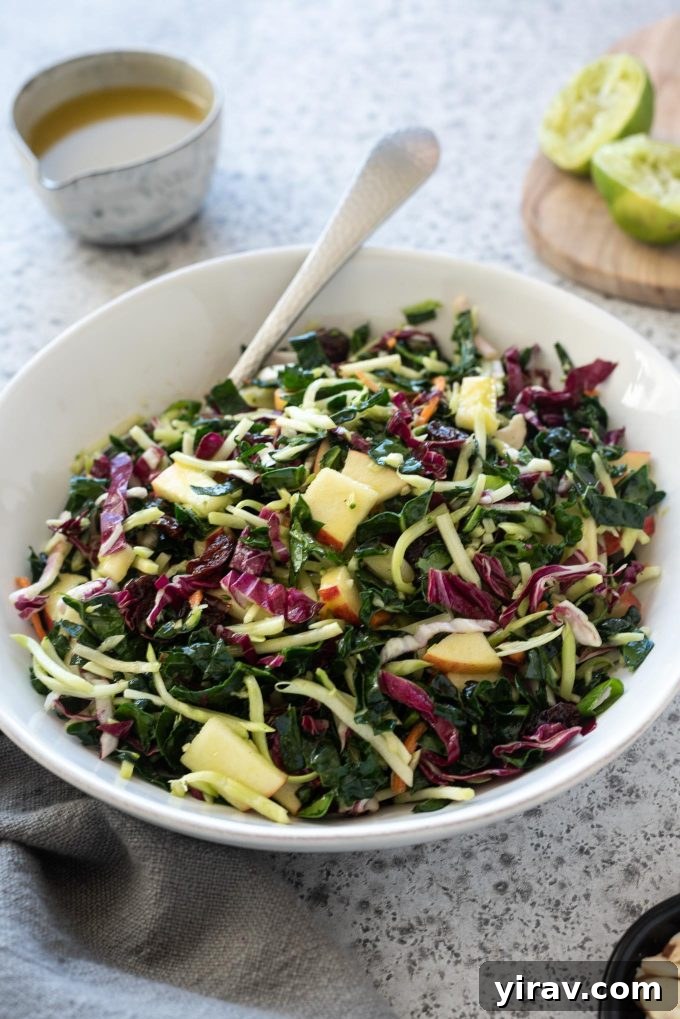 Kale slaw in a white bowl with honey lime dressing